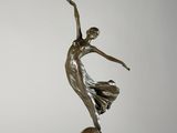 une image représentant une statue en bronze d'une femme dansant sur un socle