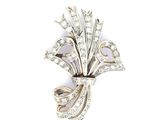 a close up of a brooch with diamonds on a white background