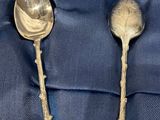 three spoons and a spoon spoon sitting in a box