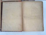 an open book with writing on it sitting on a table