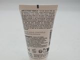 a close up of a tube of toothpaste on a white surface