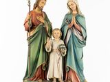 the statue of jesus and mary with a child is holding a flower