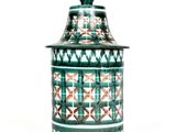 an image of a green and white jar on a white background