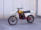 a dirt bike parked in a parking lot next to a building