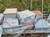 a pile of old televisions sitting on the ground in the grass