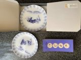 a box with two plates and a card in it
