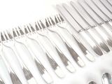 a lot of forks and spoons that are on the table