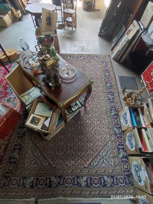 a room filled with lots of furniture and a rug