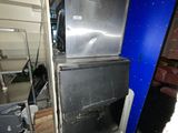a large stainless steel refrigerator in a room with a blue wall