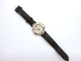 an image of a wrist watch on a white surface with a white background