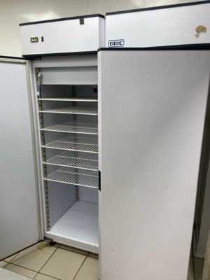 a refrigerator that is open in a kitchen
