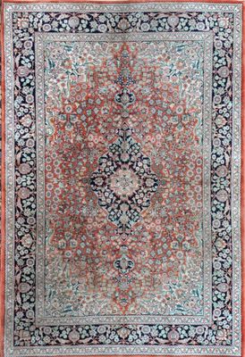 a red and black rug with a medallion design on it