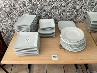 a lot of plates on a table with a price tag on it