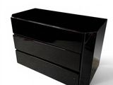 a black box with two drawers on it on a white surface