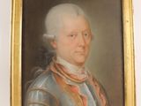 portrait of a man in armor in a gold frame on a white wall