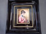 painting of a woman in a pink dress holding a flower in a black frame