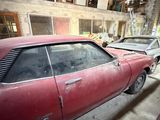 many old cars parked in the garage of this building