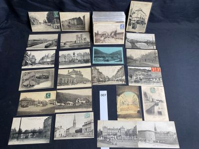 an old photo of a bunch of old postcards on a table