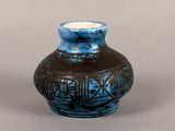 a small blue vase sitting on a table