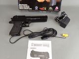 a gun that is sitting on a table next to a charger