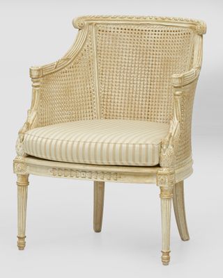 a white wicker chair with a striped cushion and wooden legs