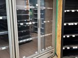 a large display case in the middle of a grocery store
