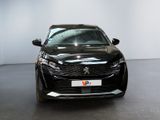 the front view of a black car parked in a showroom