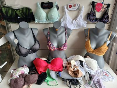 several mannequins with bras and bra tops on display in a store