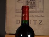 a bottle of wine sitting on a table next to a book