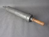 a metal rolling pin with a wooden handle on a gray surface