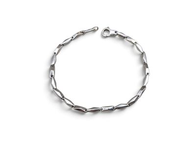 a close up of a silver bracelet on a white background