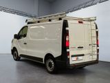 a white van with a ladder on the back of it
