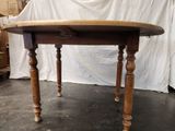 a wooden table with a wooden top on a black floor