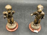 pair of antique bronze figurines of a boy and a girl