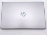 hp laptop computer sitting on a white surface with a logo on the screen