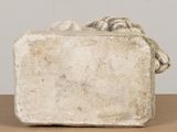 a stone sculpture of a dog on top of a table