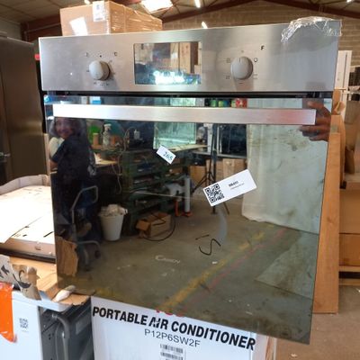 a man that is standing in front of an oven