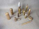 many different types of bullet shells and a pen on the table