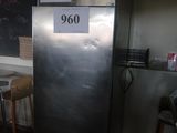 a silver refrigerator in a kitchen with a blackboard on the wall