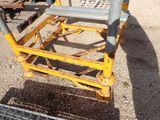 a yellow chair that is sitting in the dirt
