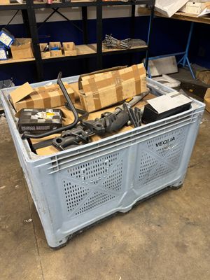 many boxes and tools on the floor in the warehouse