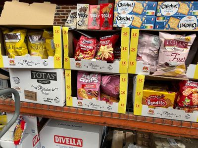 des paquets de chips et de snacks sur une étagère dans une épicerie