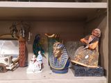 many figurines that are on a shelf in a cabinet