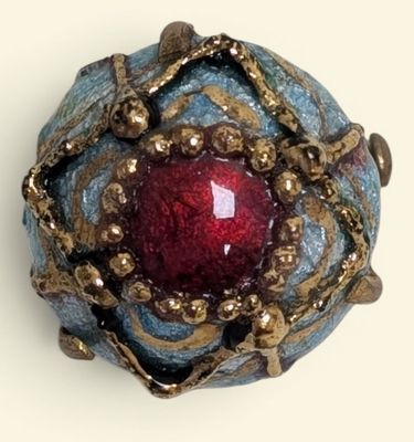 an image of a ring with a red stone in it