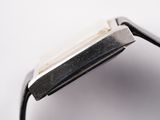 a close up of a watch on a white surface