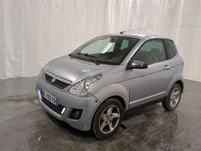a picture of a small silver car parked in a garage