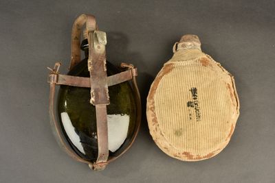 pair of antique wine bottles in leather case with cork stoppers