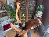 a statue of a deer with a hat on it ' s head