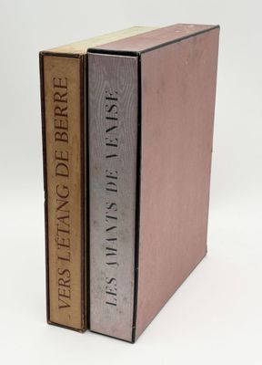 two books are stacked on top of each other on a white surface