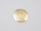 a close up of a gold coin with a picture of a woman on it